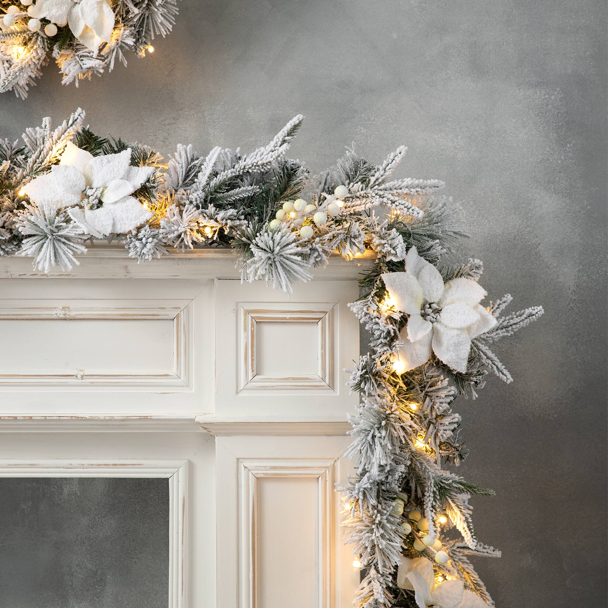 Glitzhome® 9ft. Pre-Lit Snow-Flocked Greenery Pine & Poinsettia Christmas Garlands, 2ct.